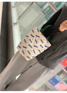 Minimalist canvas tote bag with cute letters pattern, portable handbag for daily shopping and work.