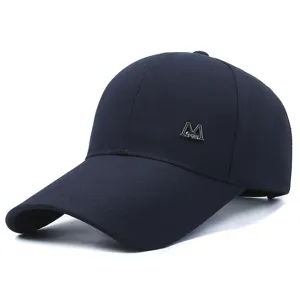 Dark blue baseball cap with extended brim and metallic M logo, casual outdoor sun protection.