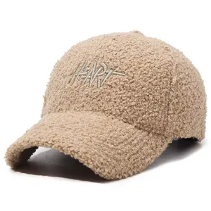 Detailed view of beige teddy fleece baseball cap with chic heart embroidery, cozy winter style.