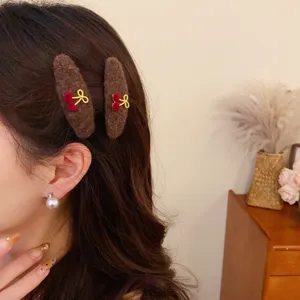 Brown plush hair clip featuring cherry and bow detail, ideal for autumn winter.