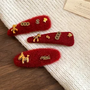 Red fuzzy hair clips feature cute gold metal horse and coin charms for winter styles.