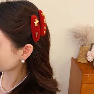 Red plush hair clip detail showing texture and gold horse charm, perfect for daily fashion styling.