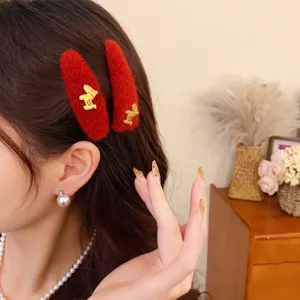 Plush horse hair clip featuring a red fuzzy design with a chic golden animal accent for women.