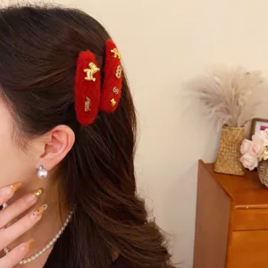 Red fuzzy hair clips with gold metal pony charms, elegant winter hair accessories for women.