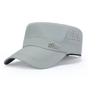 Grey flat top cap detail showing breathable mesh side holes and front metallic sports badge.