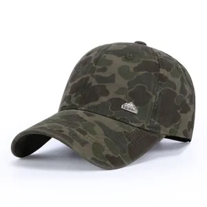 Detail view of the camouflage baseball cap showing its metal logo badge and fabric.
