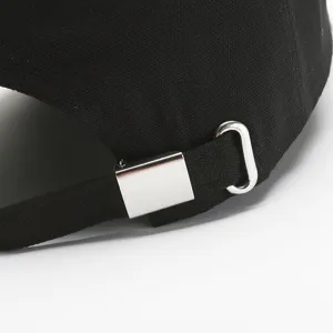 Close up view of black baseball cap metal buckle and adjustable strap detail, high quality.