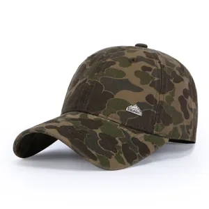 Camo baseball cap detail showing retro metal badge and durable canvas fabric construction