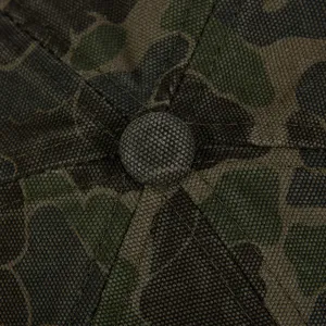 Camouflage baseball cap top view detail showing premium fabric and precise stitching work.