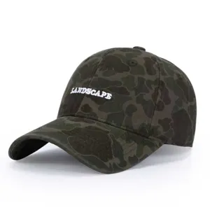 Detailed close-up view of the dark camouflage baseball cap with white landscape embroidery.