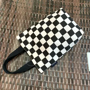Black and white checkered canvas lunch bag detail, portable thermal cup holder design.