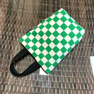 Green and white checkered canvas tote bag detail, portable lunch and cup storage bag.