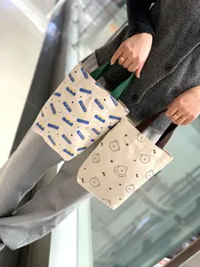 Detail shot of cute canvas tote bags with bear print and handle, perfect for daily use.