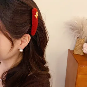 Plush red hair clip featuring a cute gold horse charm, elegant winter hair accessory for women.