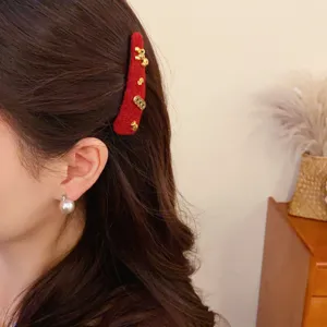 Red plush hair clip for women, vintage New Year hair accessories with cute metal charms for girls.