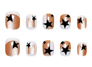 Korte nepnagels set, 10 stuks, kattenoog goud, witte rand en zwart sterrenpatroon stijl.