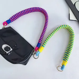 Handmade woven strap shoulder bag with colorful paracord rope and metal hardware.