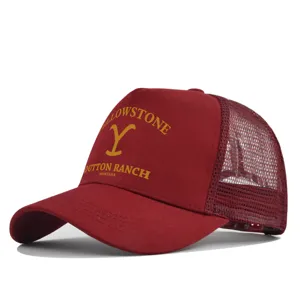 Detailed view of the maroon Yellowstone Dutton Ranch trucker mesh baseball cap with bold yellow print.