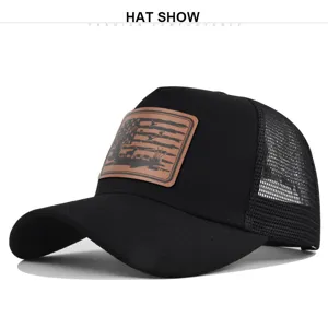 Detailed view of the black trucker hat featuring a stylish hunting leather patch and mesh back.