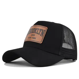 Black mesh trucker hat with brown leather patch, vintage Brooklyn baseball cap for summer sun protection.