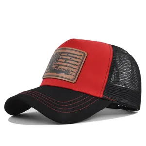 Close-up detail of the embossed leather patch and contrast stitching on the trucker hat.