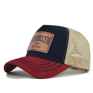 Detailed close-up view of the Brooklyn leather patch and mesh back baseball cap.