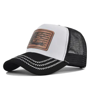 Classic black and white mesh baseball cap with brown leather patch and curved brim for outdoor.