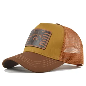 Raccoon leather patch trucker hat detail view, breathable brown mesh summer baseball cap.