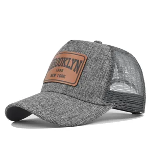 Grey mesh baseball cap with brown leather patch, classic trucker hat for summer sun protection.
