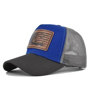 Close-up of the front leather patch and mesh detail on the blue and grey trucker cap.