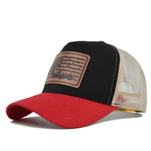 Detailed view of the hunting trucker hat featuring brown leather patch and breathable mesh back.