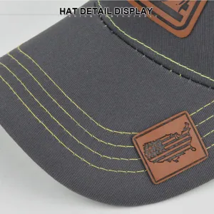 Graue Baseballcap Detailansicht, kontrastierende gelbe Nähte, stilvolles Leder-Patch-Design.