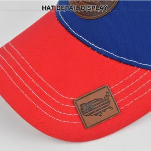 Vista detallada de gorra de béisbol roja y azul con costuras y parche de cuero.