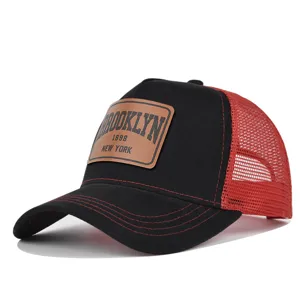 Black red mesh trucker hat detail view, vintage Brooklyn leather patch summer baseball cap.