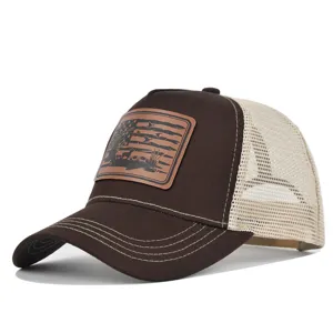 Close-up detail of the brown and beige mesh baseball hat with hunting leather patch.