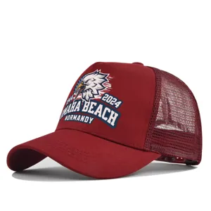 Detail view of maroon mesh trucker hat featuring eagle print and Omaha Beach Normandy text.