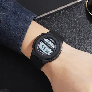Detailed view of the black digital sports watch worn on wrist, featuring durable resin strap.