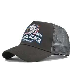 Close-up detail of dark grey trucker baseball hat with military eagle print and mesh back.
