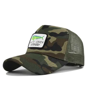 Detailed view of the camouflage trucker hat featuring embroidered fish patch and mesh back.