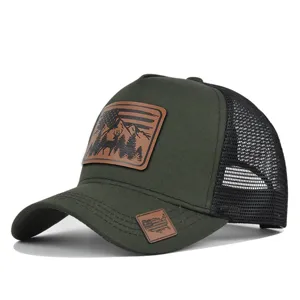Close-up detail of the leather patch and mesh structure on the vintage outdoor green hat.
