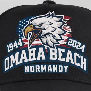 Close-up detail of a black baseball cap featuring an American eagle print and Normandy text.