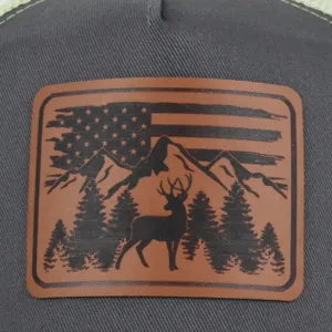 Detail shot of grey baseball cap featuring a brown leather patch with deer and flag motif.