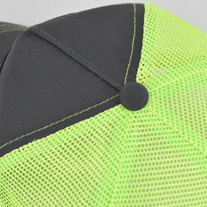 Close-up detail of the breathable mesh trucker cap featuring contrast stitching and panels.