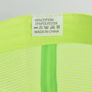 Detail shot of mesh baseball cap interior tag, 65% cotton 35% polyester composition label.