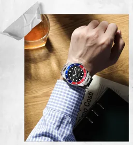 Stainless steel quartz watch detail view, black dial with Pepsi bezel worn on wrist.
