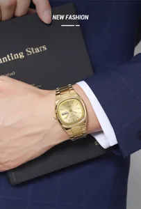 Detailed shot of men's luxury gold quartz watch with stainless steel strap and calendar display.