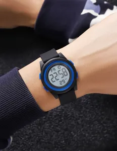 Digital watch wrist detail shot showing round electronic dial and comfortable silicone strap.