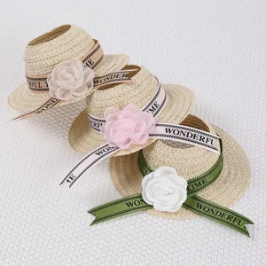 Miniature woven straw hat doll accessory with elegant floral ribbon for cute styling.