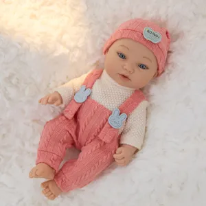 11-inch reborn baby doll toy with cute pink knit hat, sweater and overalls clothing set.