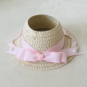 Cute miniature woven straw hat with pink ribbon bow and pearls for doll accessories.